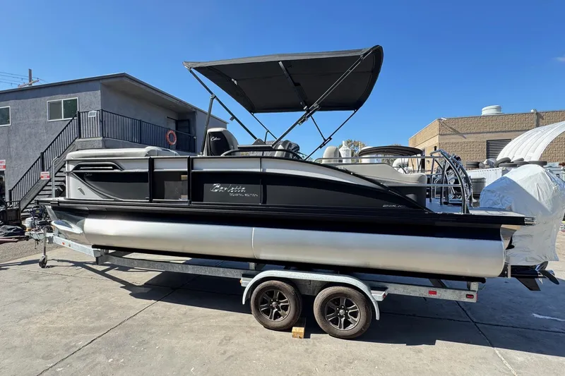 Slide: The Image of 2026 Barletta Cabrio 22UC pontoon boat on trailer, parked outdoors. - 8