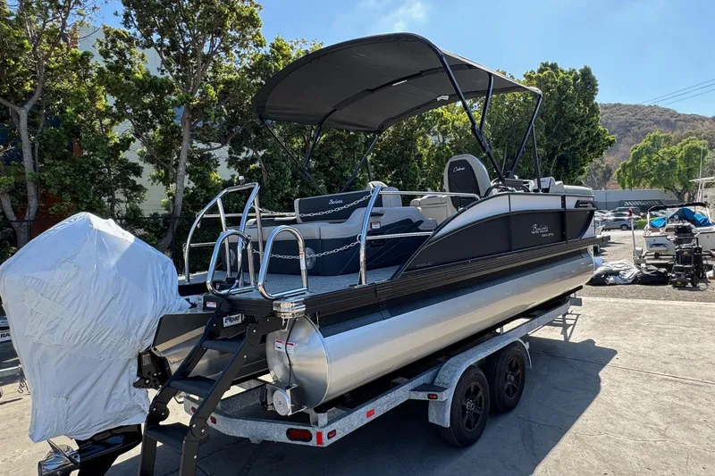 Slide: The Image of 2026 Barletta Cabrio 22UC pontoon boat on trailer, parked outdoors. - 9