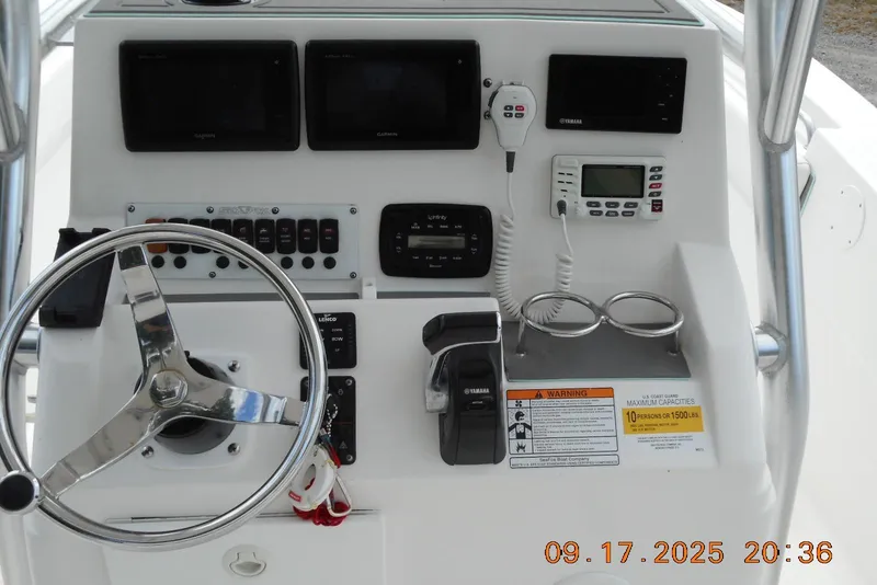 Slide: The Image of Control panel of a 2013 Sea Fox 246 Commander boat with steering wheel and instruments. - 14
