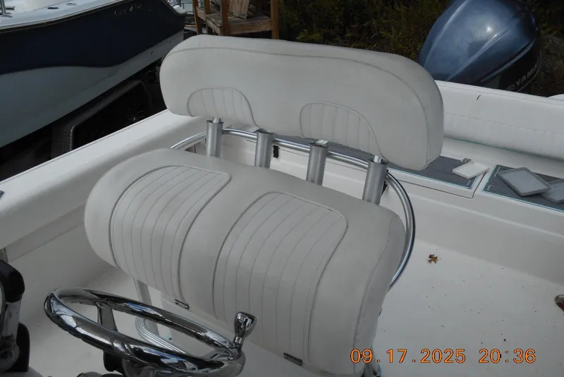 Slide: The Image of Captain's seat on a 2013 Sea Fox 246 Commander boat, featuring a sleek steering wheel. - 15