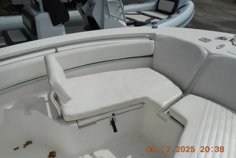 Slide: The Image of 2013 Sea Fox 246 Commander boat interior with white seating and storage. - 17