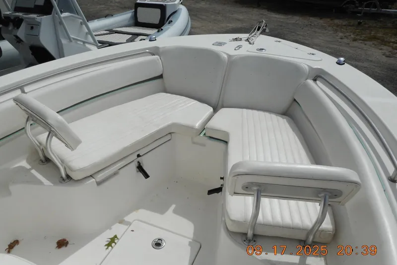 Slide: The Image of 2013 Sea Fox 246 Commander boat interior with white cushioned seating. - 19