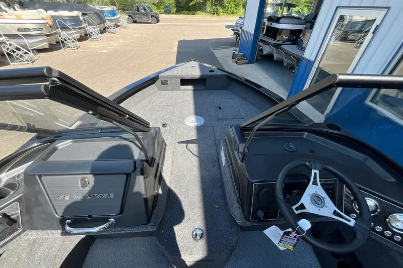 Slide: The Image of 2026 Crestliner 1850 Fish Hawk boat interior with steering wheel and dashboard. - 11