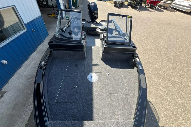 Slide: The Image of 2026 Crestliner 1850 Fish Hawk boat interior with open windshield and spacious deck. - 13