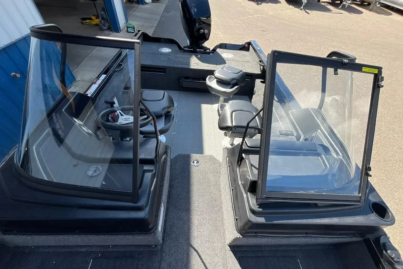 Slide: The Image of 2026 Crestliner 1850 Fish Hawk interior with dual consoles and seating. - 14