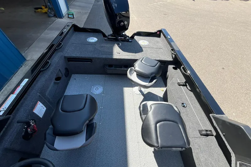 Slide: The Image of 2026 Crestliner 1850 Fish Hawk interior with seating and storage compartments. - 15
