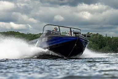 Slide: The Image of Manufacturer Provided Image: 2026 Crestliner 1850 Fish Hawk speeding on a lake under cloudy skies. - 19