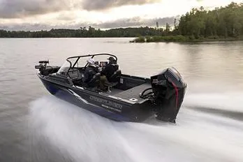 Slide: The Image of Manufacturer Provided Image: 2026 Crestliner 1850 Fish Hawk speeding on a lake, surrounded by lush greenery. - 20