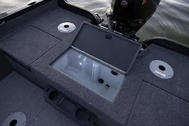 Slide: The Image of Manufacturer Provided Image: 2026 Crestliner 1850 Fish Hawk boat interior with open storage compartment and motor. - 25