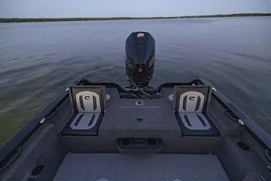 Slide: The Image of Manufacturer Provided Image: 2026 Crestliner 1850 Fish Hawk boat interior with motor, on calm water. - 26