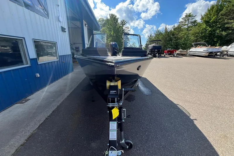 Slide: The Image of 2026 Crestliner 1850 Fish Hawk boat parked outdoors under a blue sky. - 5