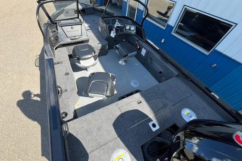 Slide: The Image of 2026 Crestliner 1850 Fish Hawk boat interior with seating and control panel. - 7