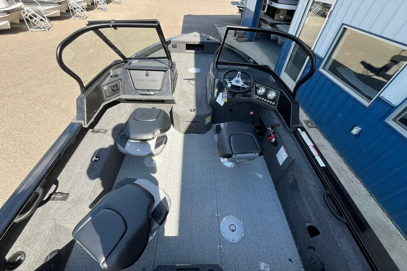 Slide: The Image of 2026 Crestliner 1850 Fish Hawk boat interior with seating and steering console. - 8