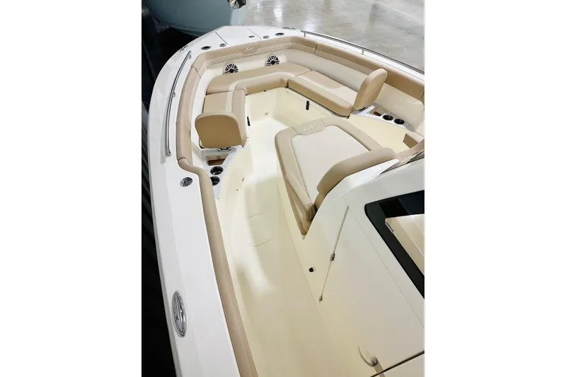Slide: The Image of 2026 Scout 260 LXF boat interior with beige seating and cup holders. - 10