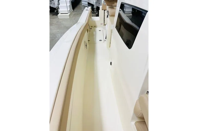 Slide: The Image of 2026 Scout 260 LXF boat interior with beige seating and sleek design. - 12