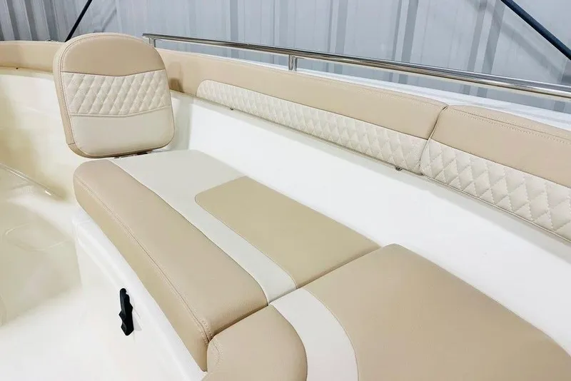 Slide: The Image of 2026 Scout 260 LXF boat interior with beige cushioned seating and quilted accents. - 13