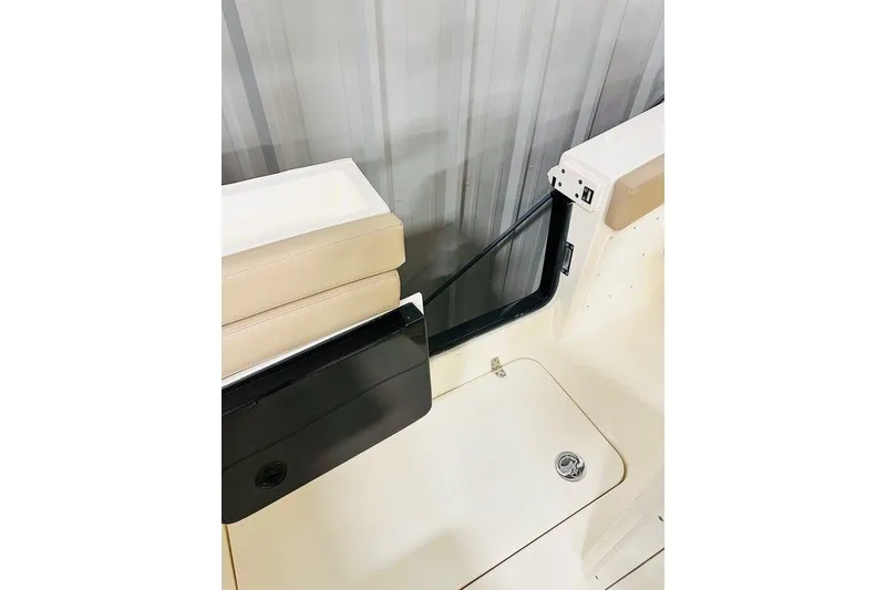 Slide: The Image of 2026 Scout 260 LXF boat interior detail with beige seating and black panel. - 19