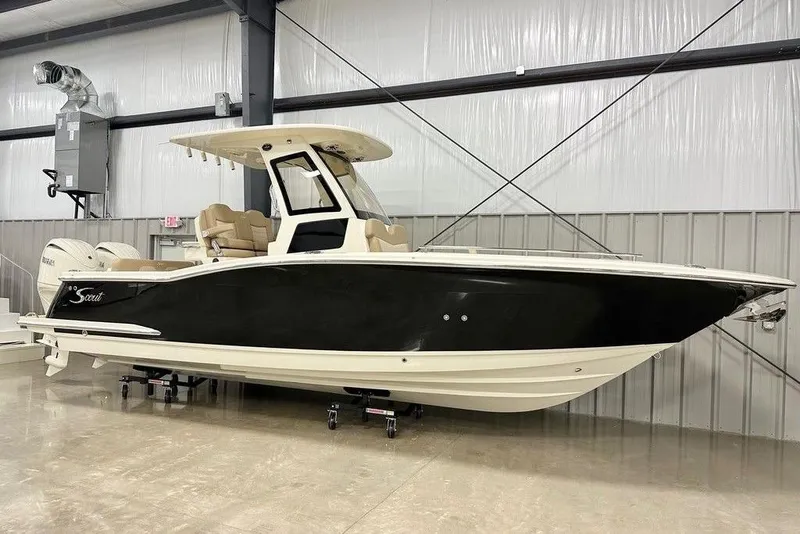 The Image of 2026 Scout 260 LXF boat in showroom, black hull, beige interior, modern design. - 2