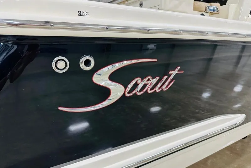 Slide: The Image of 2026 Scout 260 LXF boat with sleek black hull and stylish logo. - 24