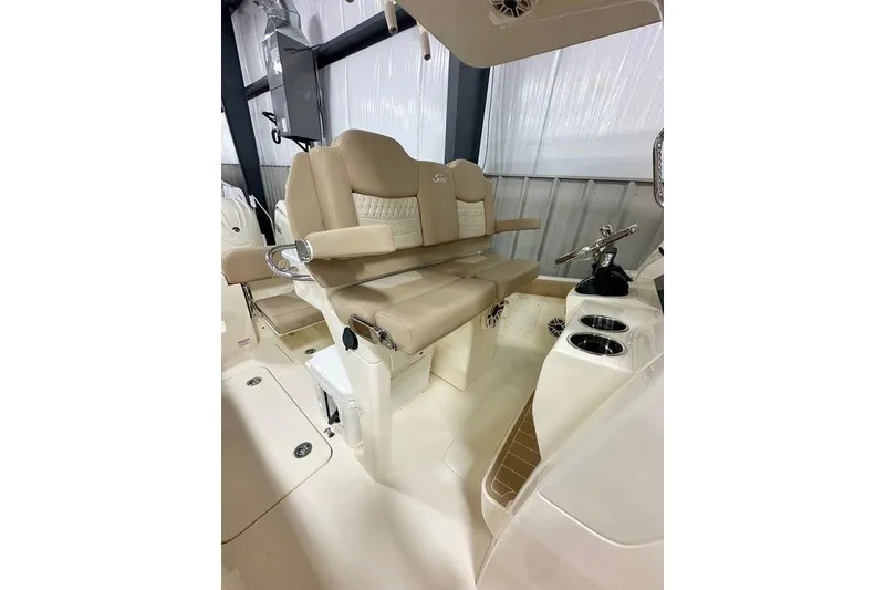 Slide: The Image of 2026 Scout 260 LXF boat interior with beige seating and steering console. - 5