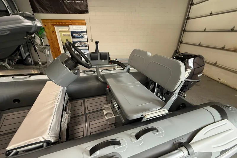 Slide: The Image of 2026 Highfield Classic 360 FCT boat interior with steering wheel and seating. - 16