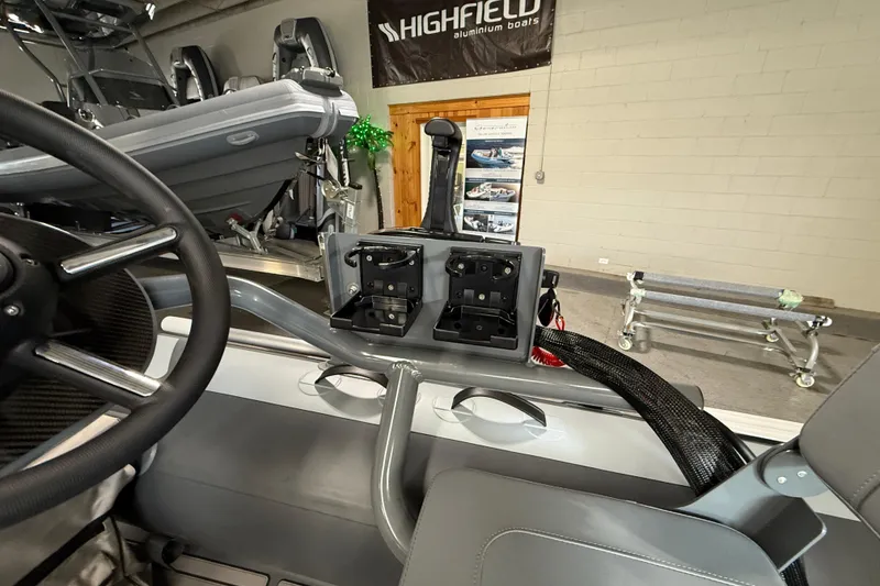 Slide: The Image of Interior view of 2026 Highfield Classic 360 FCT boat, showcasing steering wheel and control panel. - 18