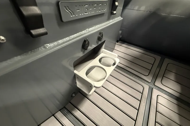 Slide: The Image of Interior of 2026 Highfield Classic 360 FCT boat with cup holder and textured flooring. - 20