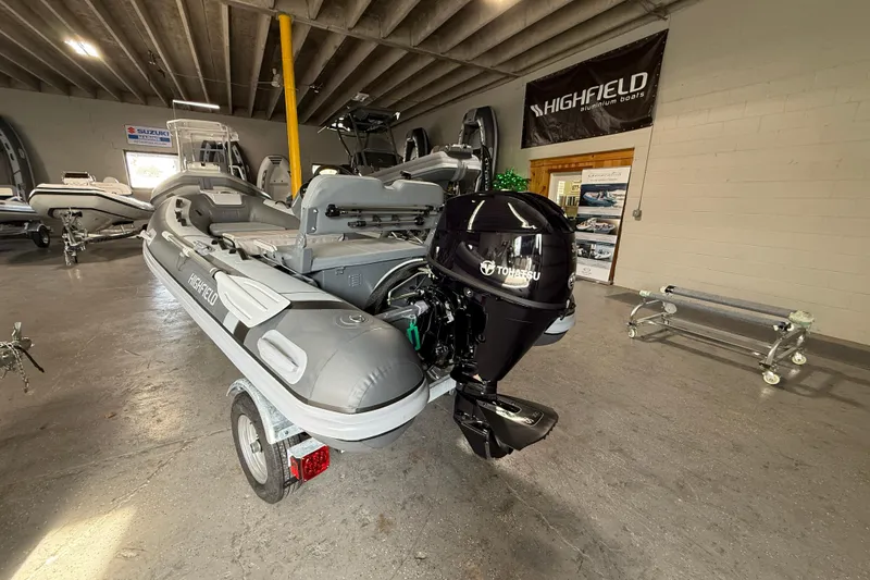 Slide: The Image of 2026 Highfield Classic 360 FCT boat with Tohatsu engine in showroom. - 4