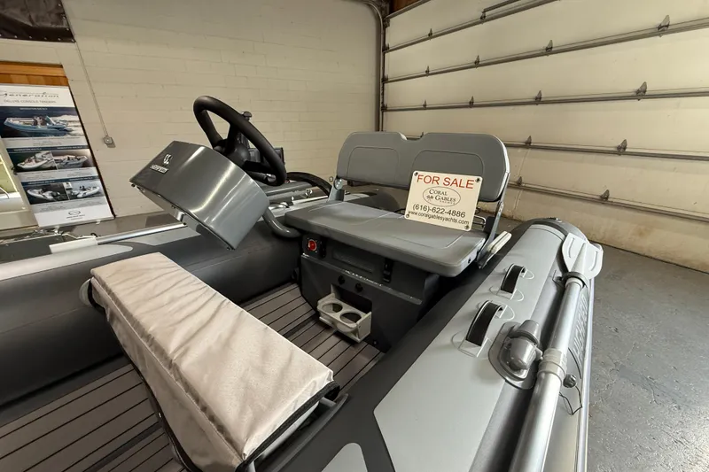 Slide: The Image of 2026 Highfield Classic 360 FCT boat interior with steering wheel, for sale sign visible. - 5