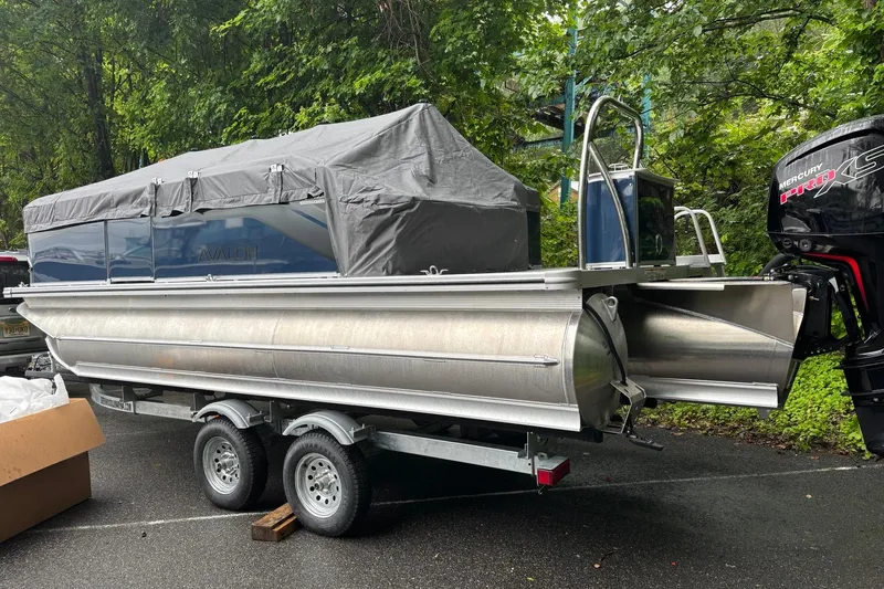The Image of 2025 Avalon Venture Cruise Rear Bench pontoon boat on trailer, covered, with Mercury Pro XS engine. - 0