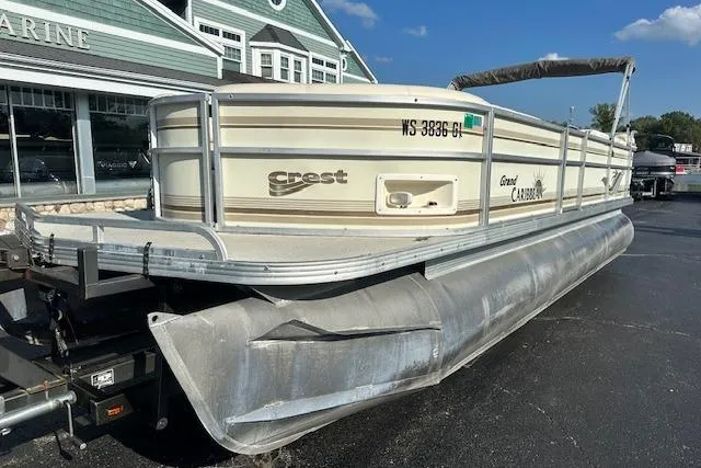 The Image of 2001 Crest Grand Caribbean pontoon boat parked at a marina under a clear blue sky. - 0