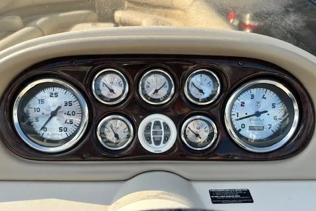 Slide: The Image of Dashboard of a 2001 Crest Grand Caribbean boat with multiple gauges and controls. - 10