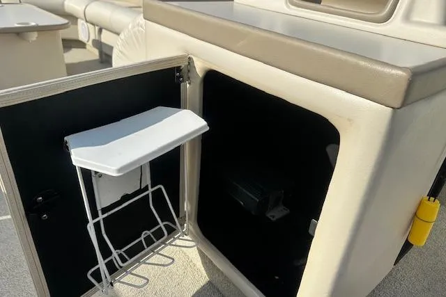 Slide: The Image of 2001 Crest Grand Caribbean boat storage compartment with open door and interior view. - 13