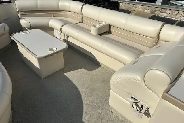 Slide: The Image of 2001 Crest Grand Caribbean boat interior with beige seating and table. - 14