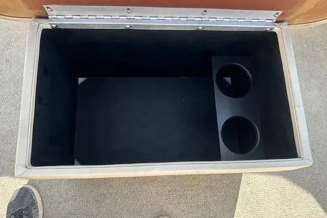 Slide: The Image of Open storage compartment with cup holders in a 2001 Crest Grand Caribbean boat. - 17