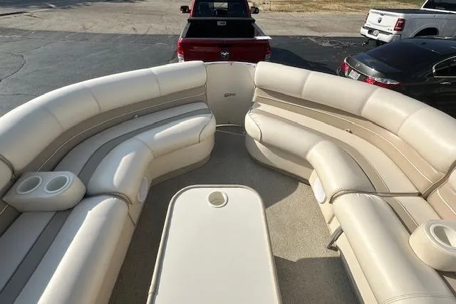 Slide: The Image of 2001 Crest Grand Caribbean boat interior with beige seating and cup holders. - 19