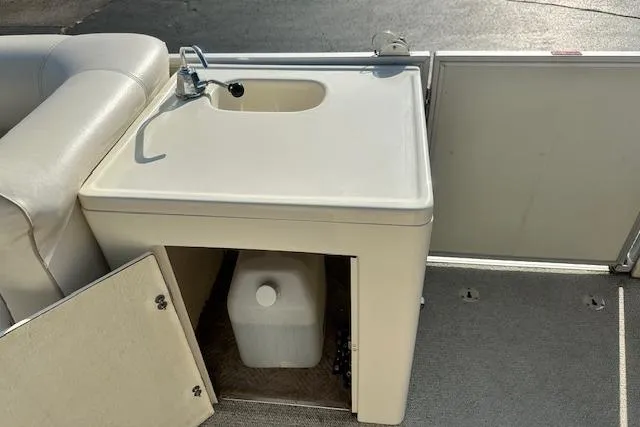 Slide: The Image of 2001 Crest Grand Caribbean boat sink with storage compartment and water container. - 23