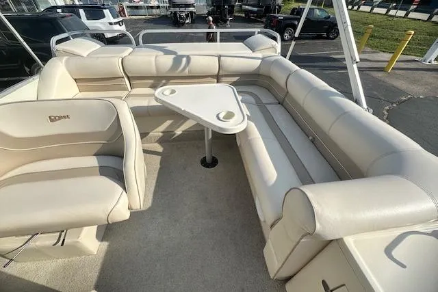 Slide: The Image of Luxurious seating area on a 2001 Crest Grand Caribbean boat with a triangular table. - 25