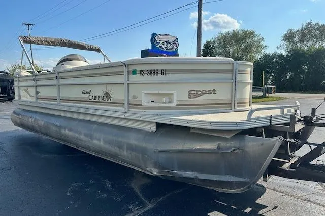 Slide: The Image of 2001 Crest Grand Caribbean pontoon boat on a trailer, parked outdoors. - 4