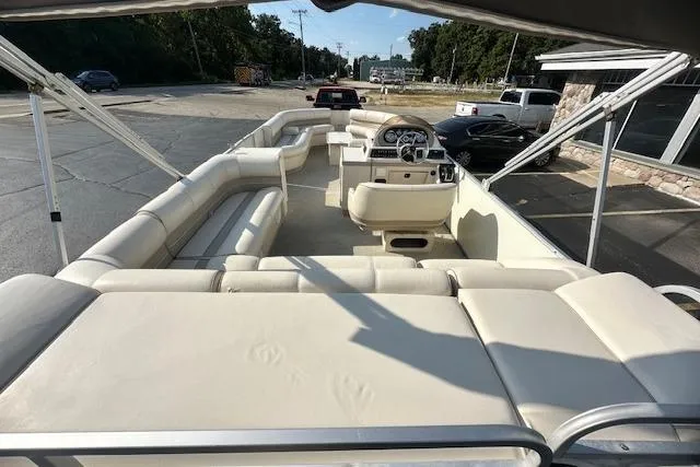 Slide: The Image of 2001 Crest Grand Caribbean pontoon boat with spacious seating and steering console, parked outdoors. - 5