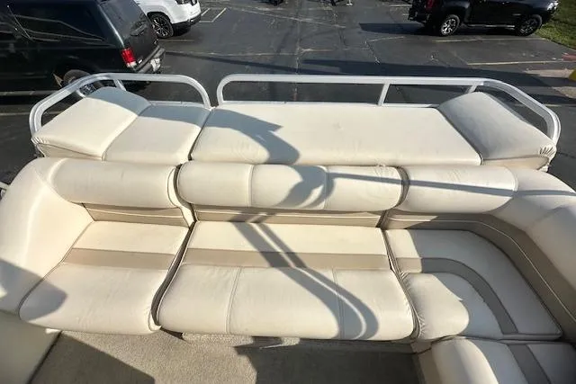 Slide: The Image of 2001 Crest Grand Caribbean boat with beige seating in a parking lot. - 6
