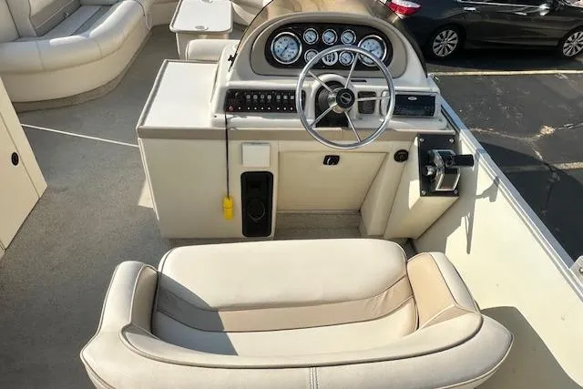 Slide: The Image of 2001 Crest Grand Caribbean boat interior with steering wheel and seating area. - 7