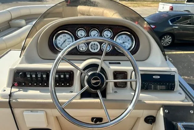 Slide: The Image of 2001 Crest Grand Caribbean boat dashboard with steering wheel and gauges. - 9