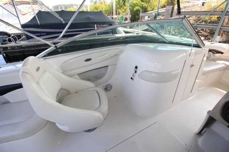 Slide: The Image of 2002 Chaparral 220 SSi boat interior with white seating and dashboard. - 11