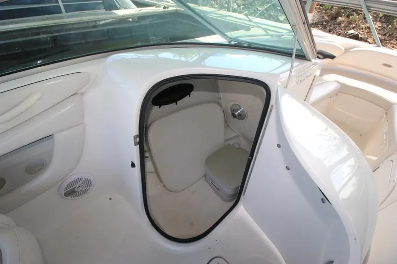 Slide: The Image of 2002 Chaparral 220 SSi boat interior with open storage compartment and seating area. - 12