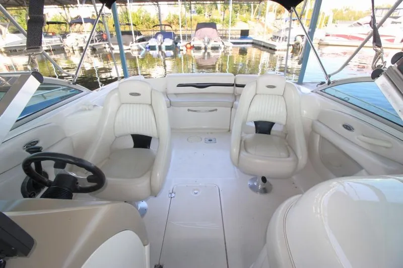 Slide: The Image of Interior of 2002 Chaparral 220 SSi boat with white seating and steering wheel. - 13