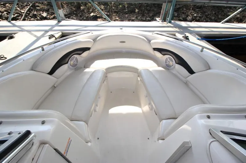 Slide: The Image of 2002 Chaparral 220 SSi boat interior with white seating and speakers. - 14