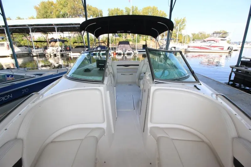 Slide: The Image of 2002 Chaparral 220 SSi boat interior with seating, docked at a marina. - 15