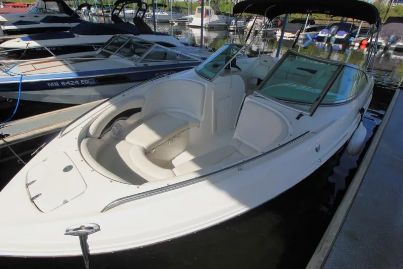 Slide: The Image of Chaparral 220 SSi 2002 boat docked, featuring open bow seating and sleek design. - 2