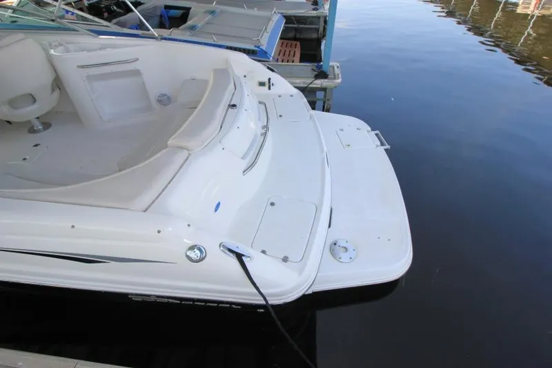 Slide: The Image of 2002 Chaparral 220 SSi boat docked, featuring spacious seating and swim platform. - 3